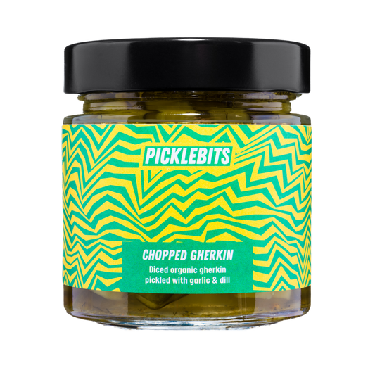 Jar of PICKLEBITS chopped gherkin with a vibrant label with black lid.
