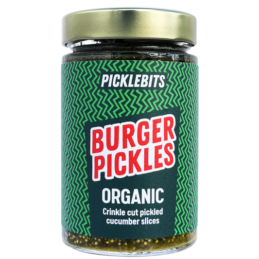 Jar of PICKLEBITS Burger Pickles with green label and gold lid on white background