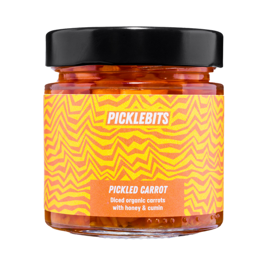 Jar of PICKLEBITS pickled carrots with a vibrant label with black lid.